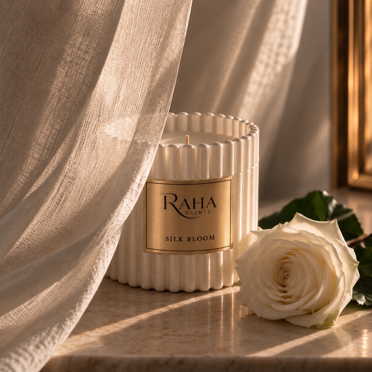 Silk Bloom candle beside a white rose in soft daylight